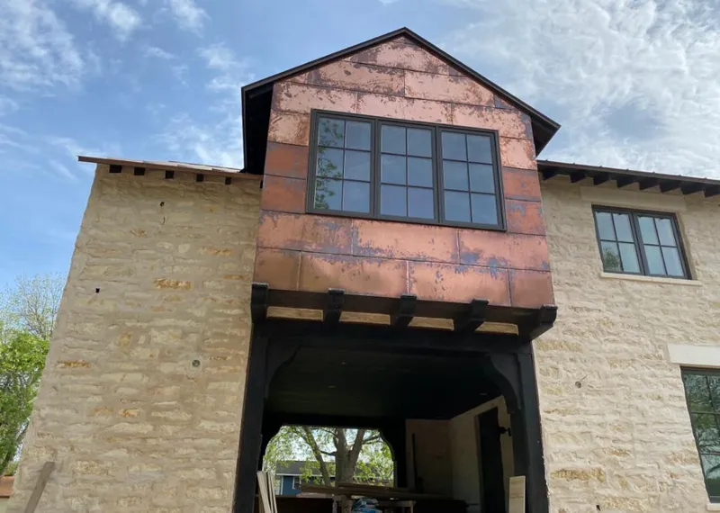 Copper metal panel facade on a stone building for Roof Repair in Blooming Grove